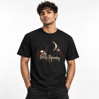 Front view of a Black T-Shirt featuring a black cat, skull, crescent moon, roses, lantern, and ornate “Stay Spooky” lettering.
