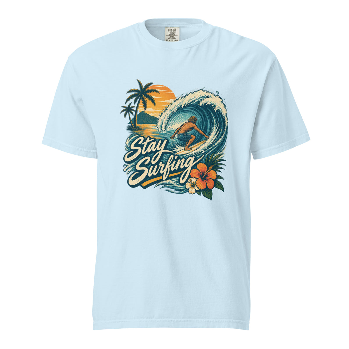 Chambray T-shirt with vintage “Stay Surfing” artwork showing a surfer riding a teal wave with palm trees and hibiscus flowers