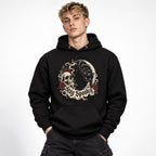 Unisex hoodie in Black worn by a model in an upper-body front relaxed pose on a clean white background