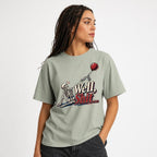 Well Shit Skeleton With Balloon t shirt in Bay worn by a studio model in an upper-body side pose on a clean white background