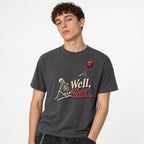 Well Shit Skeleton With Red Balloon t shirt in Graphite worn by a studio model in an upper-body three quarter left pose on a clean white background