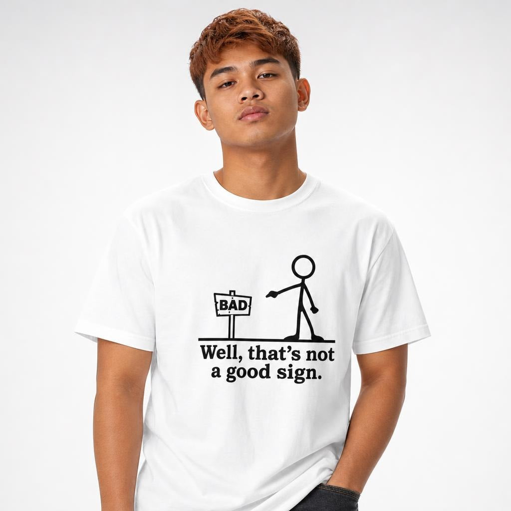 Model wearing a white T-shirt with a minimalist stick figure beside a sign reading “BAD” and the caption “Well, that’s not a good sign.”