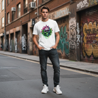Man wearing a white t-shirt with a colorful cannabis skull design on a street with graffiti.