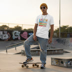 Non-binary person wearing a white autism awareness t-shirt.