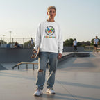 White non-binary person wearing a white autism awareness puzzle heart sweatshirt.