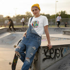 Non-binary person wearing a white autism lightning bolt doodle t-shirt.