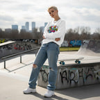 Non-binary person wearing a white "Be Kind" autism awareness puzzle piece sweatshirt.