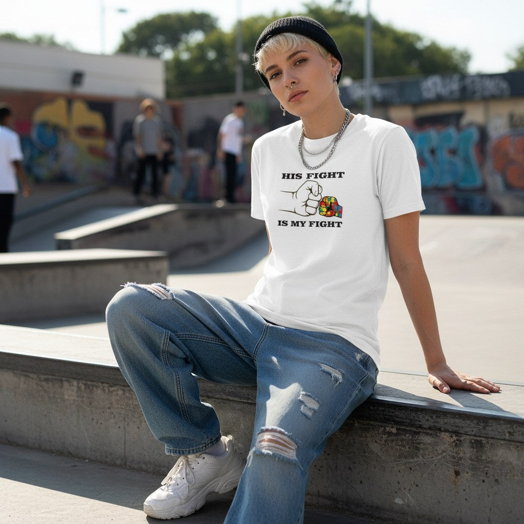 White non-binary person wearing a white His Fight Is My Fight autism solidarity t-shirt.