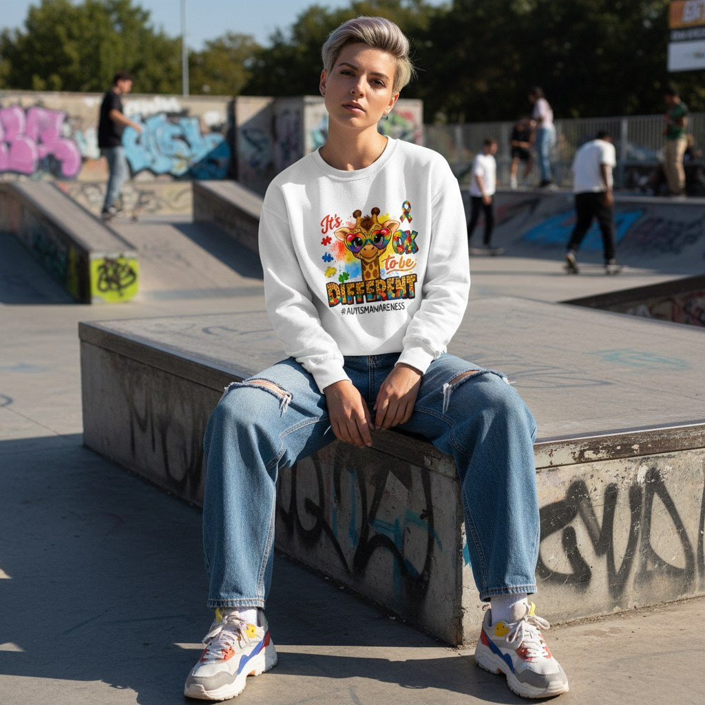 White non-binary person wearing a white its ok to be different giraffe sweatshirt.