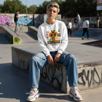 White non-binary person wearing a white its ok to be different giraffe sweatshirt.