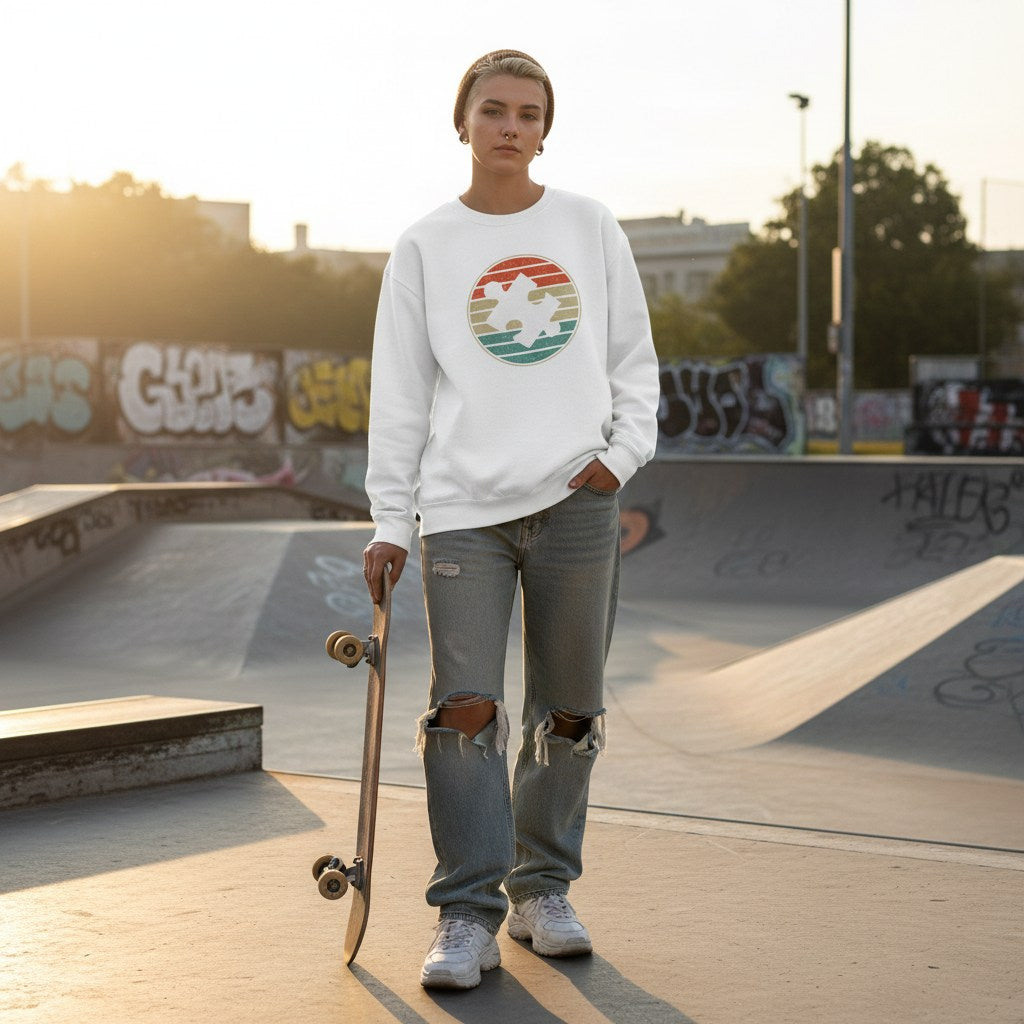 White non-binary person wearing a white retro sunset puzzle piece autism sweatshirt.