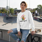 White non-binary person wearing a white Support Squad autism awareness sweatshirt.
