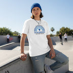 Non-binary person wearing a white "We Wear Blue" autism awareness t-shirt.