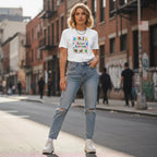 White woman wearing a white autism awareness t-shirt.