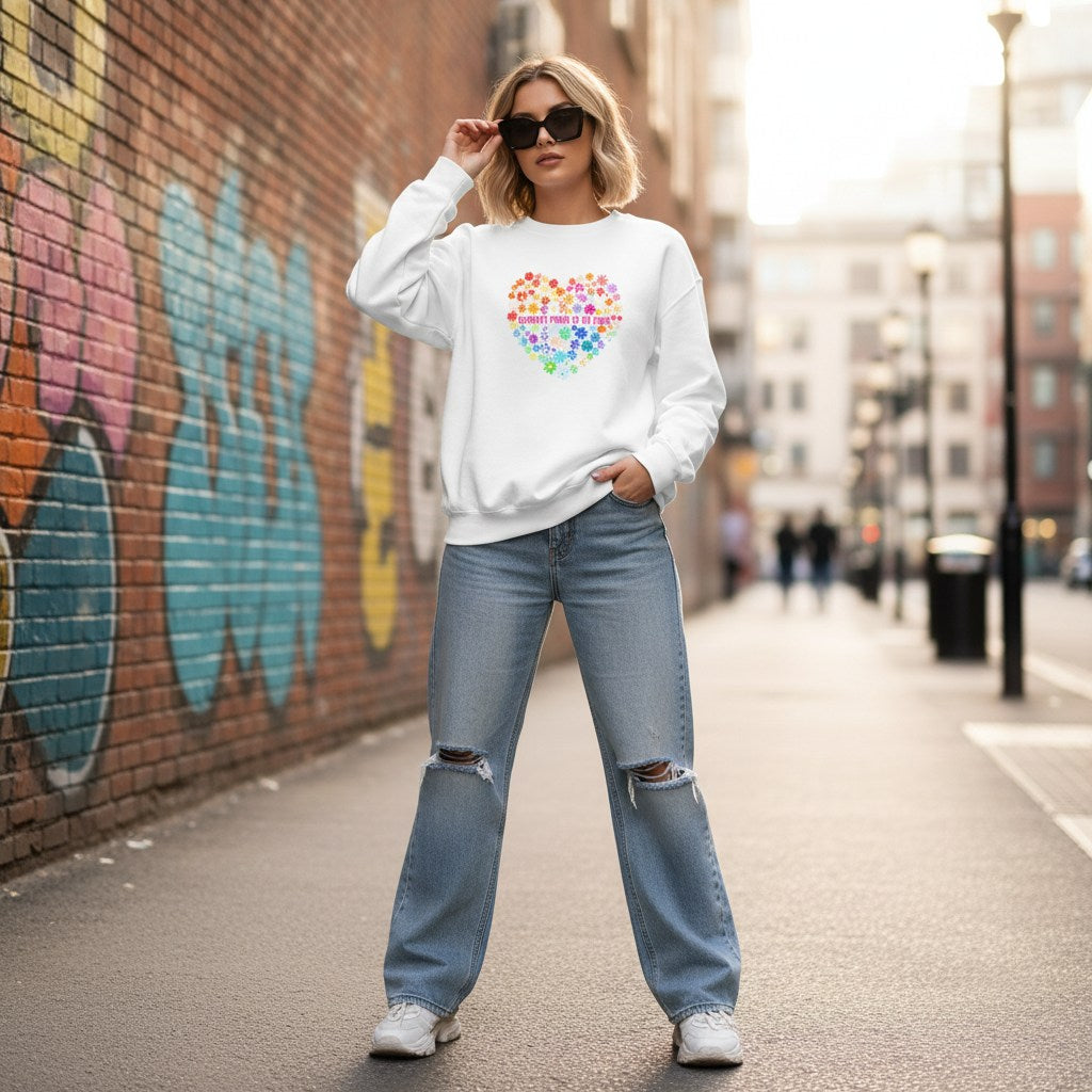 White woman wearing a white celebrate minds sweatshirt.