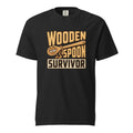 Front view of a black T-shirt with a cartoon wooden spoon character and the words “WOODEN SPOON SURVIVOR.”