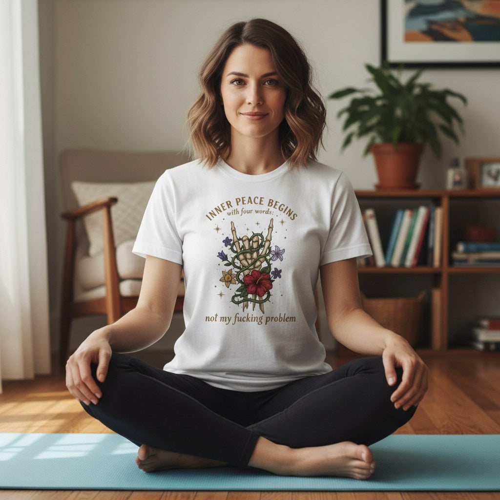 A man sitting cross-legged on a yoga mat in a bright, modern room, practicing meditation.